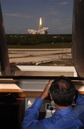 In this photo provided by NASA, The Space Shuttle Discovery and its crew lift off as seen from firing room four in the Launch Control Center, as NASA Administrator, Dr. Michael Griffin watches the launch, Tuesday, July 4, 2006, at Cape Canaveral, Fla. NASA's first-ever Fourth of July manned launch came after two weather delays and a new crack in foam insulation on the fuel tank. Shuttle managers said early video images showing small pieces of debris breaking away were not troubling. (AP Photo/NASA, Bill Ingalls)